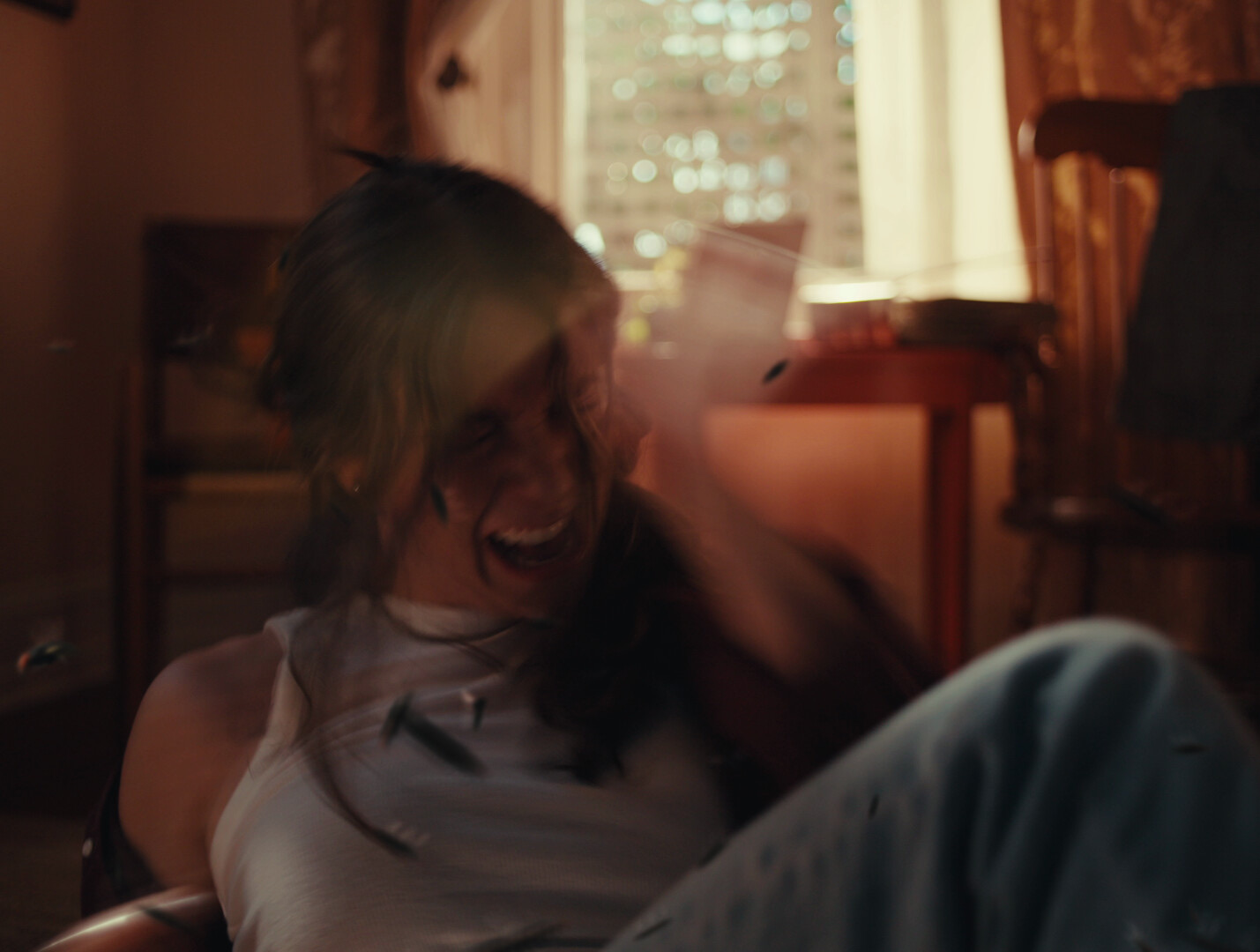 Still from The Flies: the woman recoils as flies fill the room